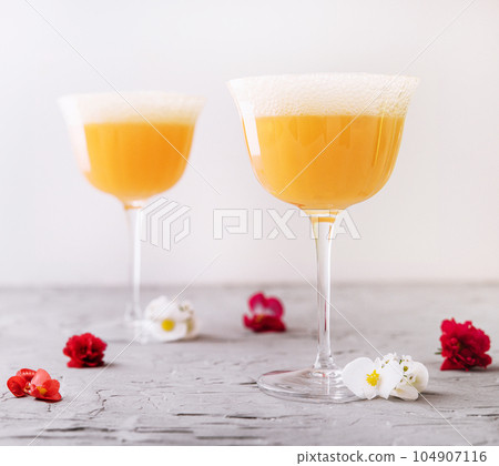 Mimosa alcohol cocktail with orange juice and dry champagne Mimosa alcohol cocktail with orange juice and dry champagne 104907116