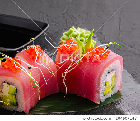 sushi rolls of red tuna on black stone 104907148