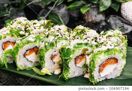 Sushi rolls with salmon, cream cheese in seaweed Sushi rolls with salmon, cream cheese in seaweed 104907194