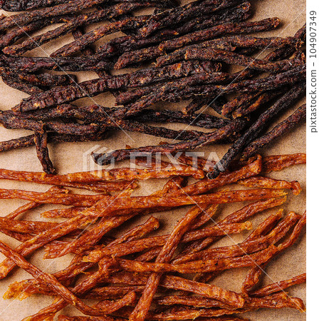 Beef and chiken jerky on wooden board 104907349