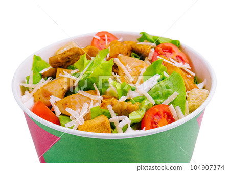 Paper bowl with Caesar salad isolated on white Paper bowl with Caesar salad isolated on white 104907374