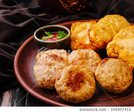 meatballs and fried chicken chops on plate 104907418