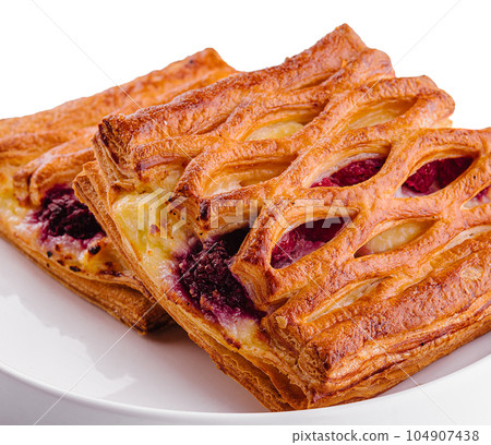 Delicious puff pastry with raspberry jam Delicious puff pastry with raspberry jam 104907438