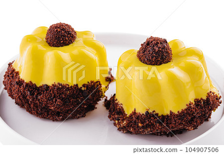 dessert in yellow icing on plate 104907506