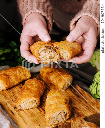 woman holds a romanian pastry with cabbage woman holds a romanian pastry with cabbage 104907584