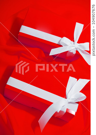 Red gifts on a yellow background Red gifts on a yellow background 104907676