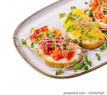 bruschetta with cream cheese and multi-colored grilled bell pepper 104907685