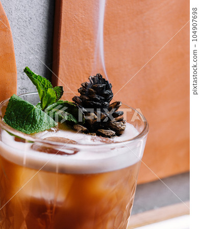 Cocktail with preserved sweet cedar cone 104907698
