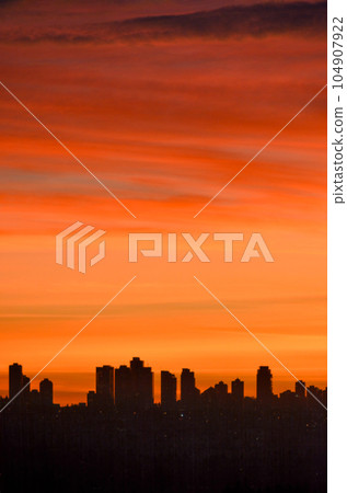 Urban silhouette of buildings on sunset sky background Urban silhouette of buildings on sunset sky background 104907922