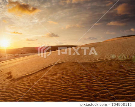 White sand dunes on sunrise with sun, Mui Ne, Vietnam White sand dunes on sunrise with sun, Mui Ne, Vietnam 104908115