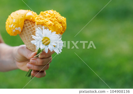 Refreshing ice cream in waffle cones with lemon flavour Refreshing ice cream in waffle cones with lemon flavour 104908136