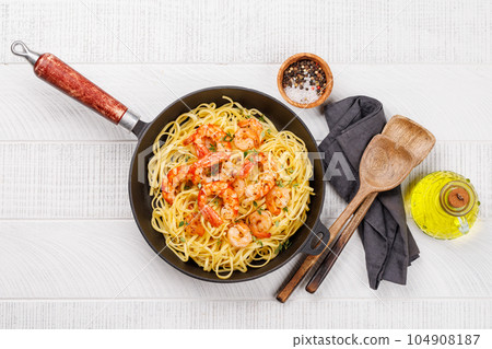 A delightful Italian pasta adorned with shrimps 104908187