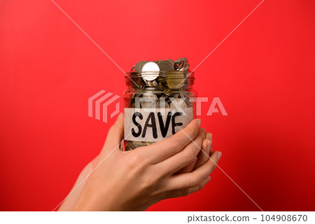 Hand holding coins in glass jar, Financial business investment, Growing money, People saving money, Money for future, Money saving concept Hand holding coins in glass jar, Financial business investment, Growing money, People saving money, Money for future, Money saving concept 104908670