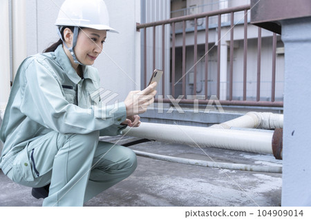 A female engineer conducting a field survey 104909014