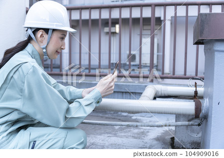 A female engineer conducting a field survey 104909016