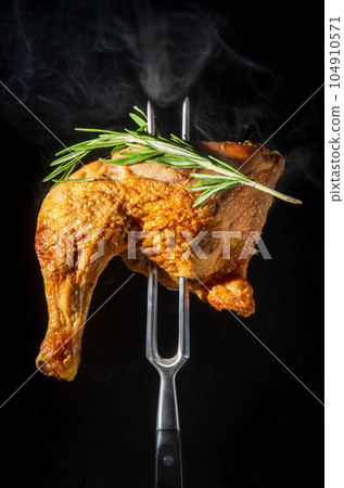 Steamed smoked chicken thigh with rosemary on a fork. Menu for restaurant or hotel 104910571