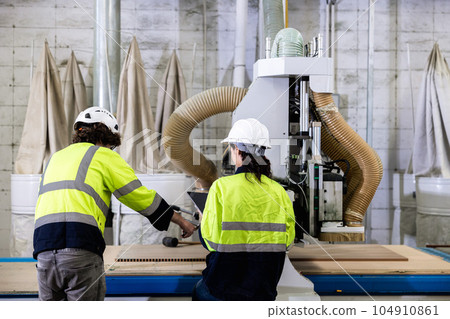 team worker work control operate wood milling machine in wood furniture workshop. technician staff teamwork working with modern industry machine team worker work control operate wood milling machine in wood furniture workshop. technician staff teamwork working with modern industry machine 104910861