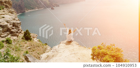 Woman travel summer sea. Portrait of a happy woman on a background of beautiful sea. Rear view of a woman in a white shirt. Freedom and happiness Woman travel summer sea. Portrait of a happy woman on a background of beautiful sea. Rear view of a woman in a white shirt. Freedom and happiness 104910953