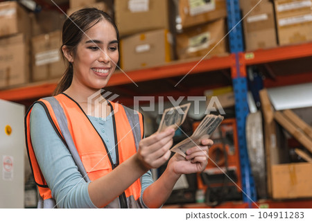 Engineer warehouse staff employee happy glad to recieve salary increase. industry woman worker happy glad with overtime bonus money payday 104911283