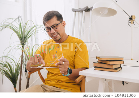 adult asian business man work at home trading stock exchang using modern technology overlay calble stick graph chart 104911306