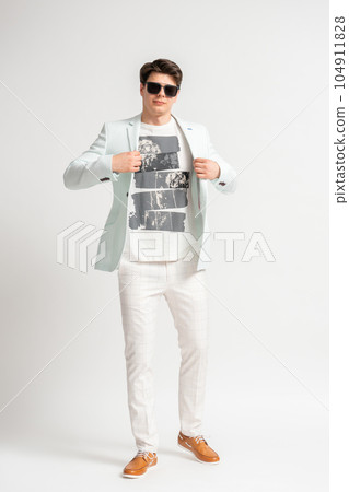Man in casual business jacket and sunglasses posing on white background Man in casual business jacket and sunglasses posing on white background 104911828