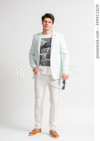 Man in casual business jacket and sunglasses posing on white background Man in casual business jacket and sunglasses posing on white background 104911829