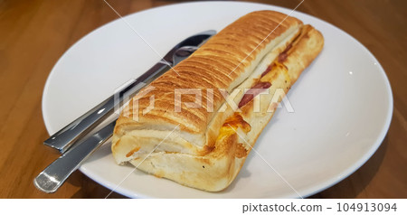 Grilled smoked beef mushroom Panini or sandwich served with white plate on the wooden table. Grilled smoked beef mushroom Panini or sandwich served with white plate on the wooden table. 104913094