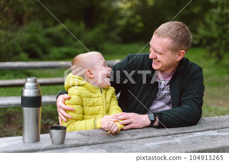 Happy Family: Father And Child Boy Son Playing And Laughing In Autumn Park, Sitting On Wooden Bench And Table. Father And Little Kid Having Fun Outdoors, Playing Together. Father And Son Sitting On A Happy Family: Father And Child Boy Son Playing And Laughing In Autumn Park, Sitting On Wooden Bench And Table. Father And Little Kid Having Fun Outdoors, Playing Together. Father And Son Sitting On A 104913265