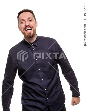 Portrait of a handsome, unshaven man, dressed in a dark blue shirt, standing against a white background. Self confident man. Portrait of a handsome, unshaven man, dressed in a dark blue shirt, standing against a white background. Self confident man. 104913438