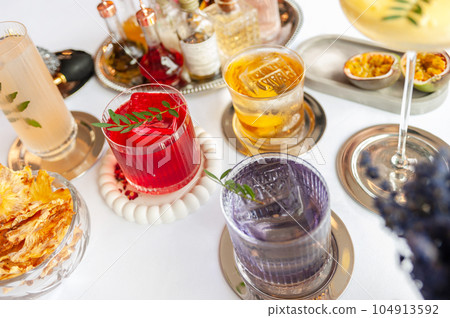 Colorful summer cocktails in glasses on the white table.  104913592