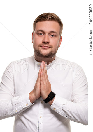 Office worker keeps palm together in please gesture. Bearded man wishing and looking at camera. Isolated on white. Office worker keeps palm together in please gesture. Bearded man wishing and looking at camera. Isolated on white. 104913620