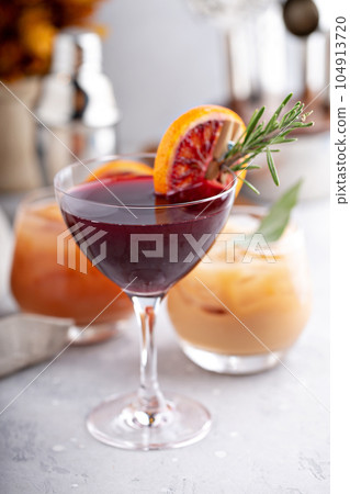 Winter blood orange and rosemary cocktail 104913720