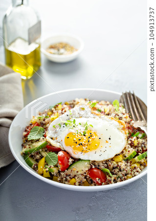 Fresh quinoa tabbouleh salad with fried egg 104913737