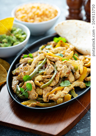 Chicken and bell peppers fajitas 104913750