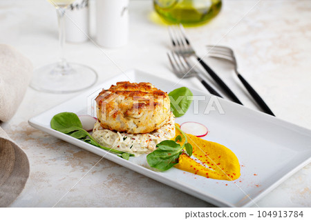 Gourmet plated fishcake with vegetables Gourmet plated fishcake with vegetables 104913784