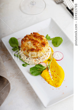 Gourmet plated fishcake with vegetables 104913788