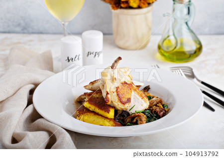 Gourmet plated chicken leg 104913792