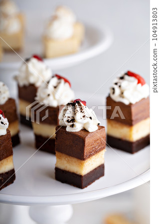 Bite sized dessert, three chocolates cake 104913803
