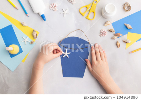 Paper bucket of shells summer idea for kids craft in kindergarten hands ocean's day 104914890