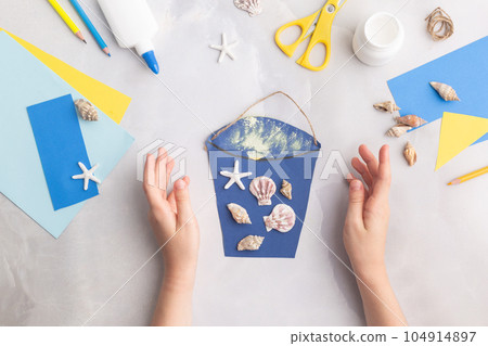 Paper bucket of shells summer idea for kids craft in kindergarten hands ocean's day 104914897