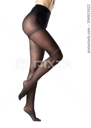 Legs of a woman in black capron tights on white background 104915022