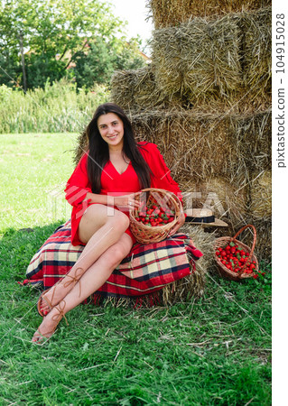 Portrait of Smiling Woman with Basket of Strawberries 104915028