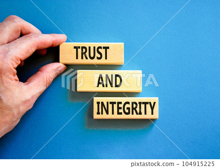 Trust and integrity symbol. Concept words Trust and integrity on wooden blocks. Businessman hand. Beautiful blue background. Business, psychological and trust and integrity concept. Copy space. Trust and integrity symbol. Concept words Trust and integrity on wooden blocks. Businessman hand. Beautiful blue background. Business, psychological and trust and integrity concept. Copy space. 104915225