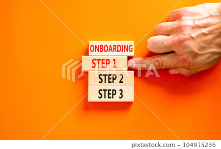 Time to step 1 onboarding symbol. Concept words Onboarding step 1 on wooden block. Businessman hand. Beautiful orange table orange background. Business success step 1 onboarding concept. Copy space. 104915236