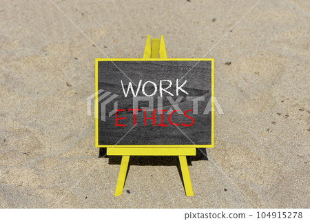 Work ethics symbol. Concept words Work ethics on beautiful black chalk blackboard on a beautiful sand beach background. Business and Work ethics concept. Copy space. Work ethics symbol. Concept words Work ethics on beautiful black chalk blackboard on a beautiful sand beach background. Business and Work ethics concept. Copy space. 104915278