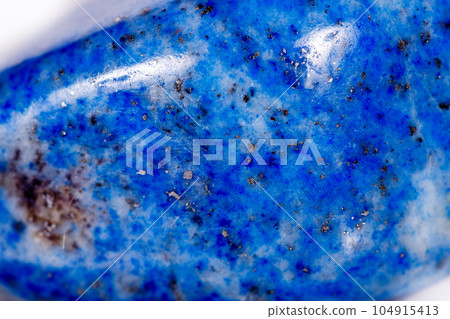 Macro mineral stone blue lapis lazuli (afghanistan) on white background Macro mineral stone blue lapis lazuli (afghanistan) on white background 104915413