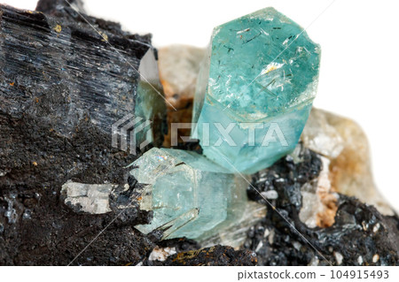 Macro mineral stone Aquamarine and black tourmaline, Schorl on a white background Macro mineral stone Aquamarine and black tourmaline, Schorl on a white background 104915493