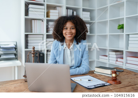 A young women African American lawyer lawsuit studying cases for clients in a law firm to fight against their parties in the courts. law and attorney concepts 104915616