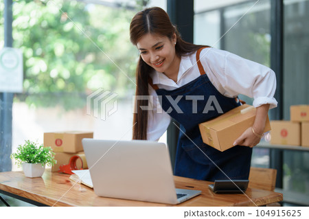 Starting small business entrepreneur of independent Asian woman smiling using computer laptop with cheerful success Starting small business entrepreneur of independent Asian woman smiling using computer laptop with cheerful success 104915625