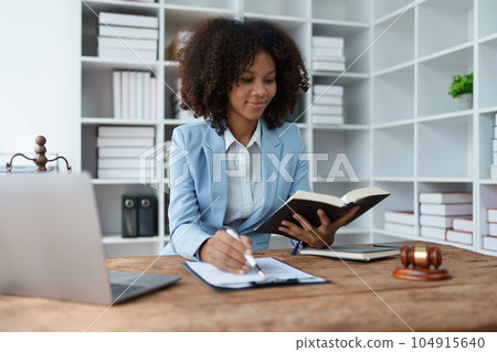 A young women African American lawyer lawsuit studying cases for clients in a law firm to fight against their parties in the courts. law and attorney concepts 104915640